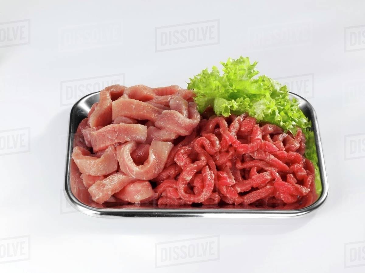 Veal and beef, cut into strips Stock Photo Dissolve