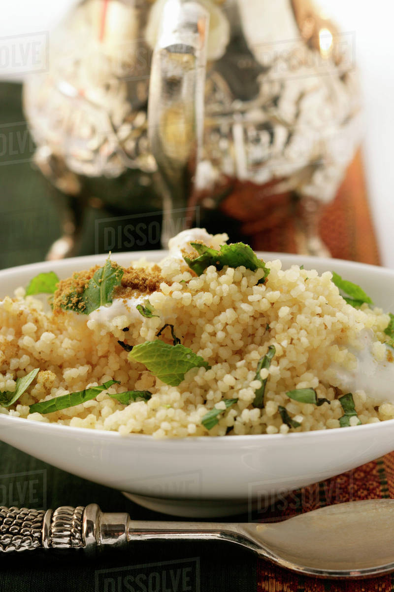 Couscous with yoghurt, mint and cinnamon Stock Photo Dissolve