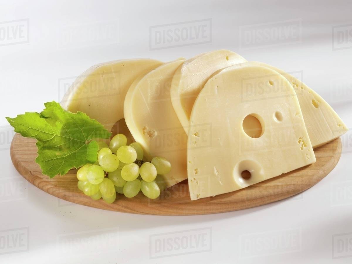 Swiss cheese with grapes Stock Photo Dissolve