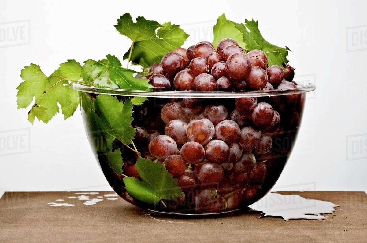 Grapes in a glass bowl Stock Photo Dissolve