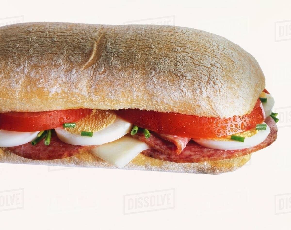 Ciabatta sandwich filled with tomato, salami, egg & cheese Stock