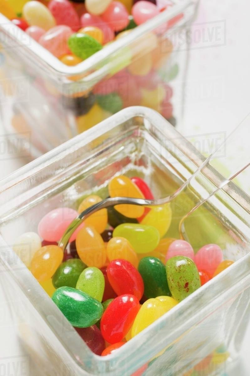 Coloured jelly beans in two storage jars (closeup) Stock Photo