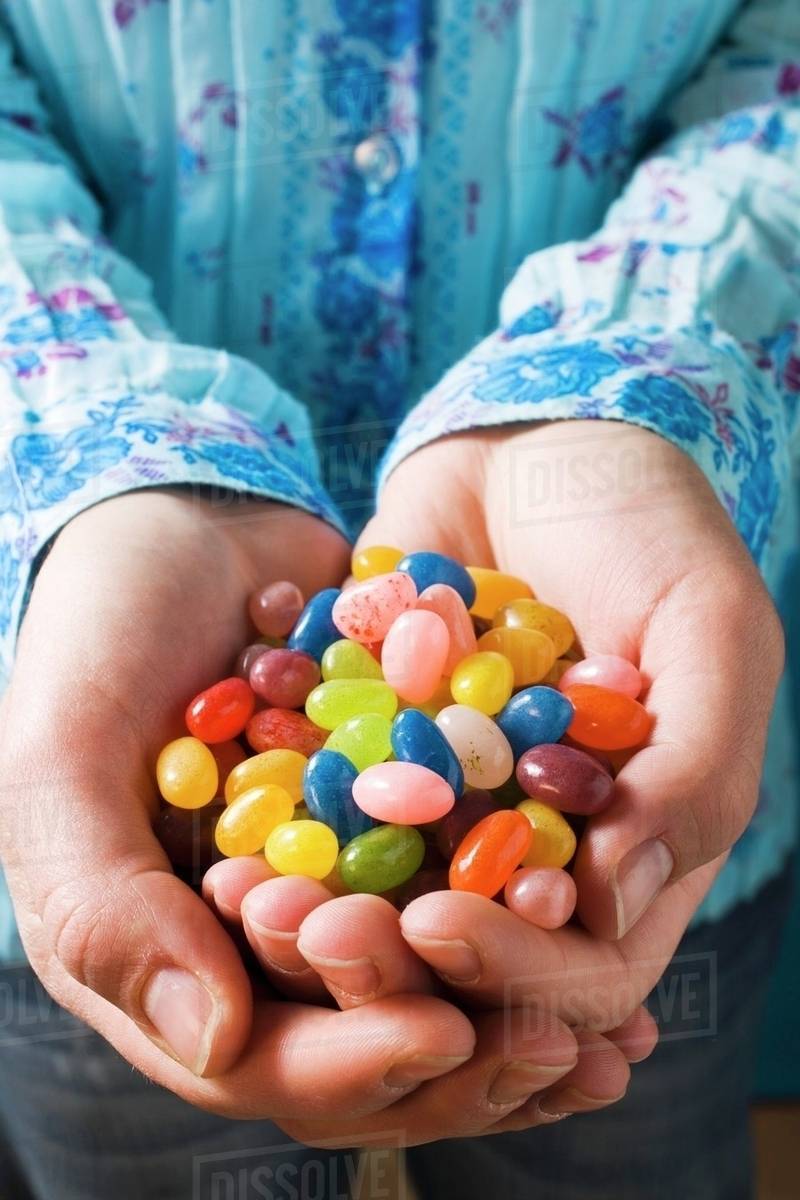 Hands holding jelly beans Stock Photo Dissolve