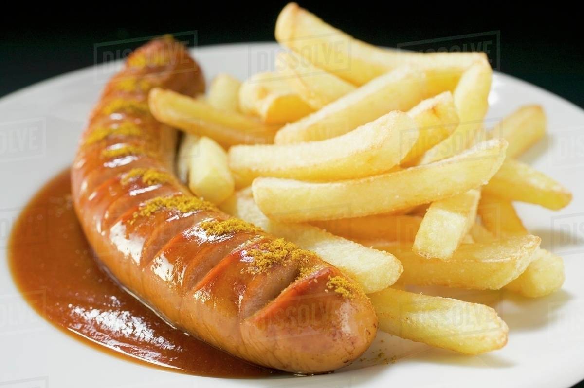 Currywurst (sausage with ketchup & curry powder) & chips on plate