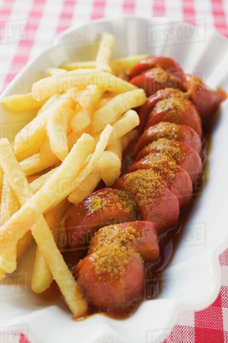 Currywurst (sausage with ketchup & curry powder) and chips Stock