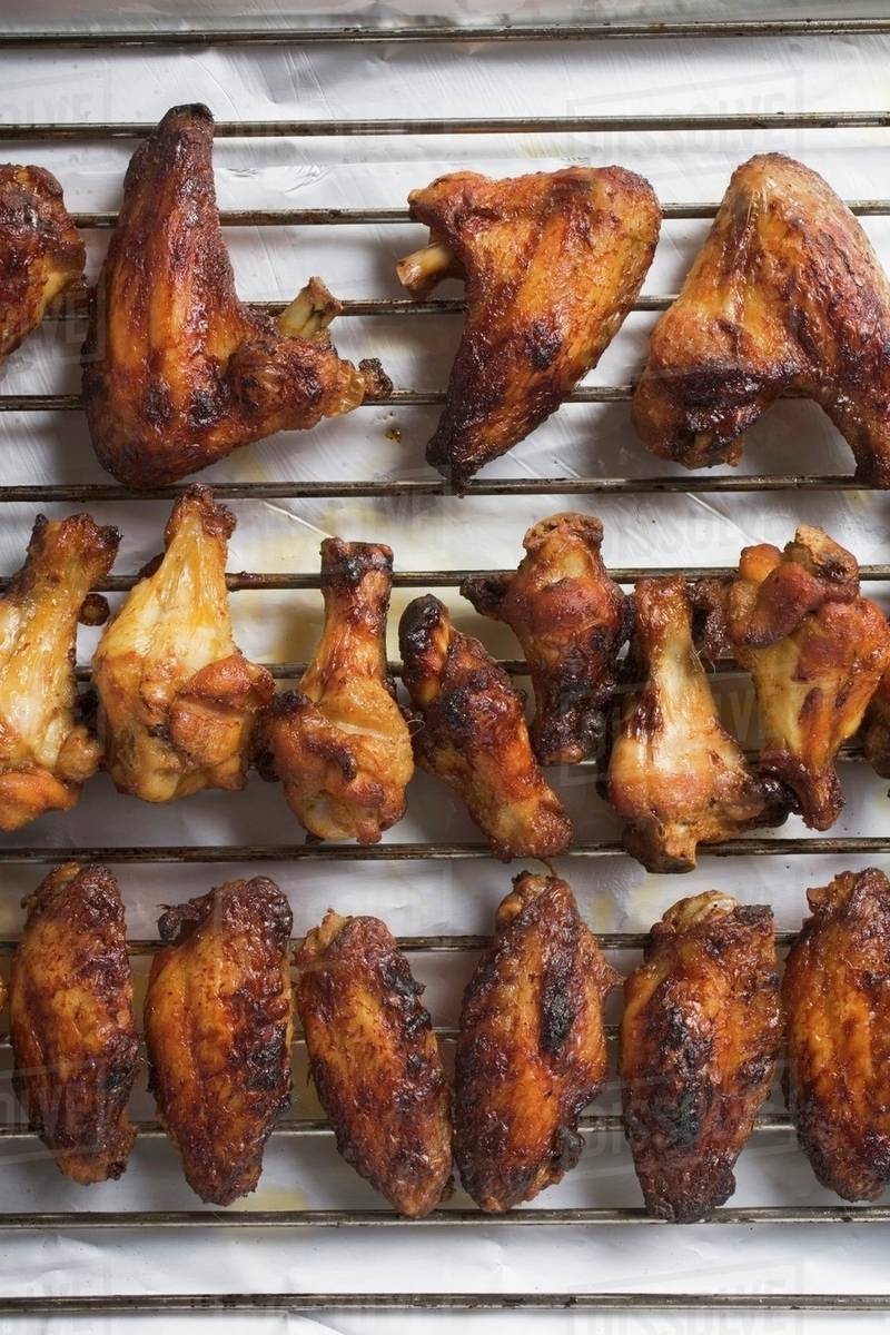Grilled chicken wings on rack Stock Photo Dissolve