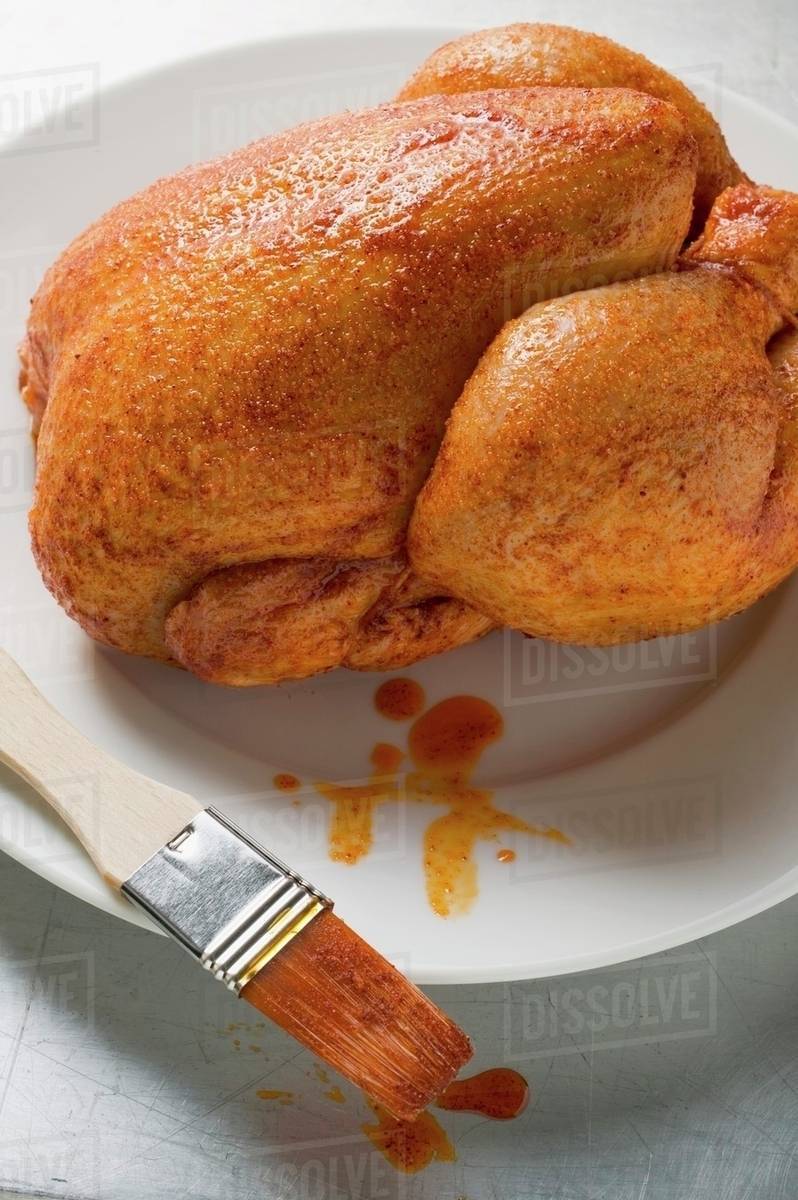 Fresh marinated chicken with basting brush Stock Photo Dissolve