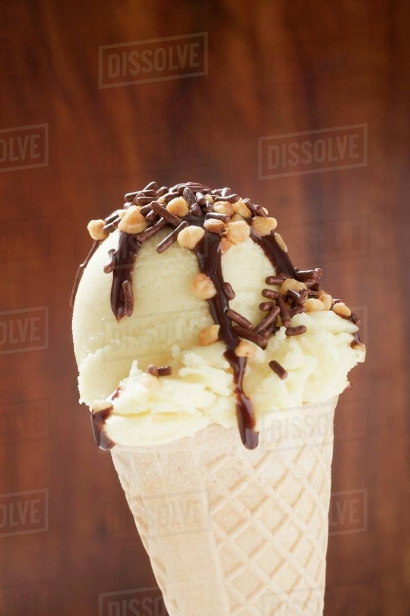 Cone of nut ice cream with chocolate sauce Stock Photo Dissolve