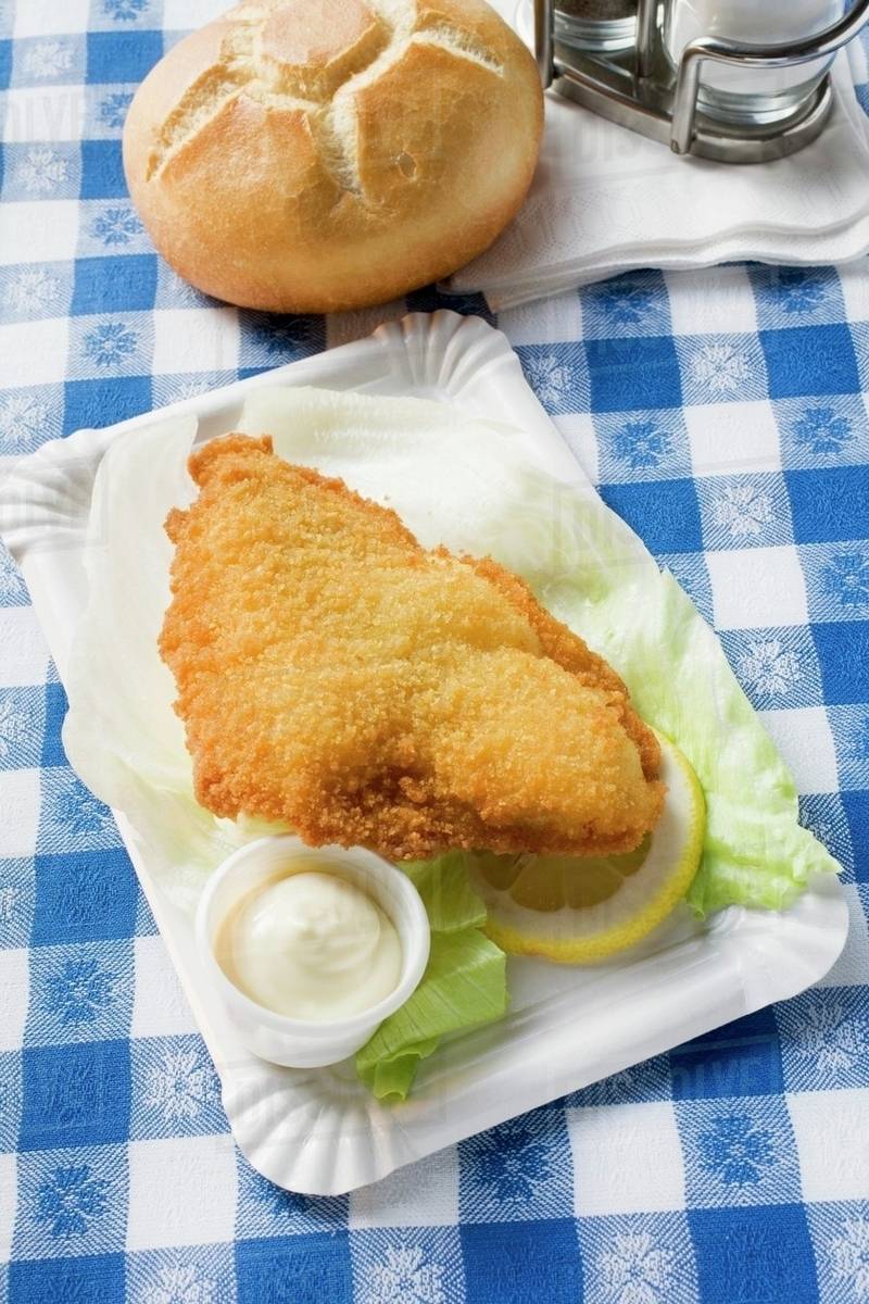 Fish fillet with mayonnaise and bread roll in snack bar Stock Photo Dissolve