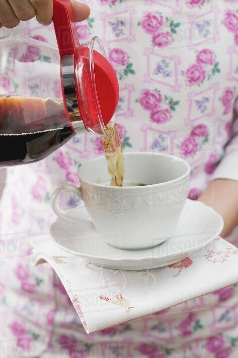Woman Pouring Coffee Into Cup Woman Pouring Coffee Into Cup