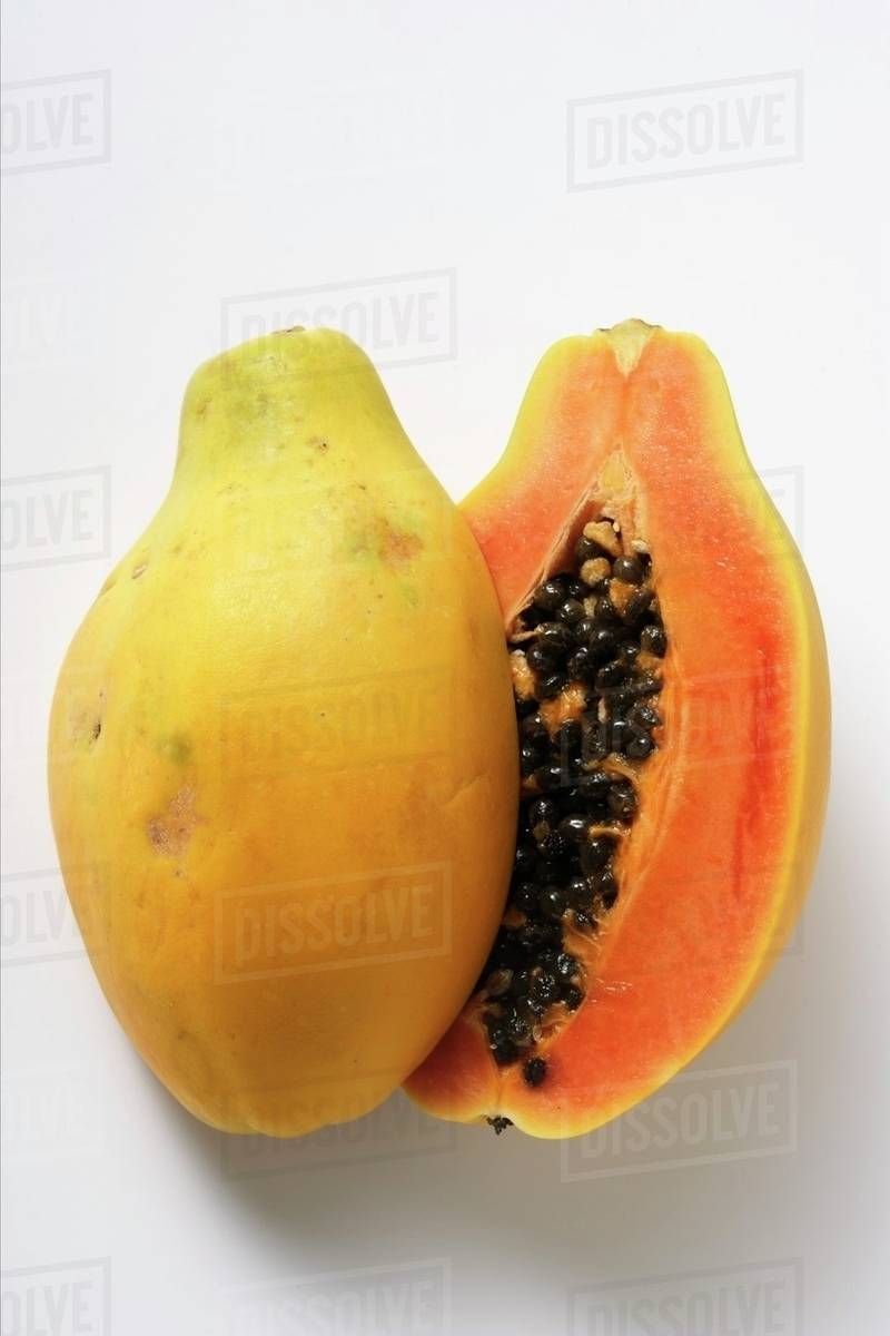 Two whole papayas Stock Photo Dissolve