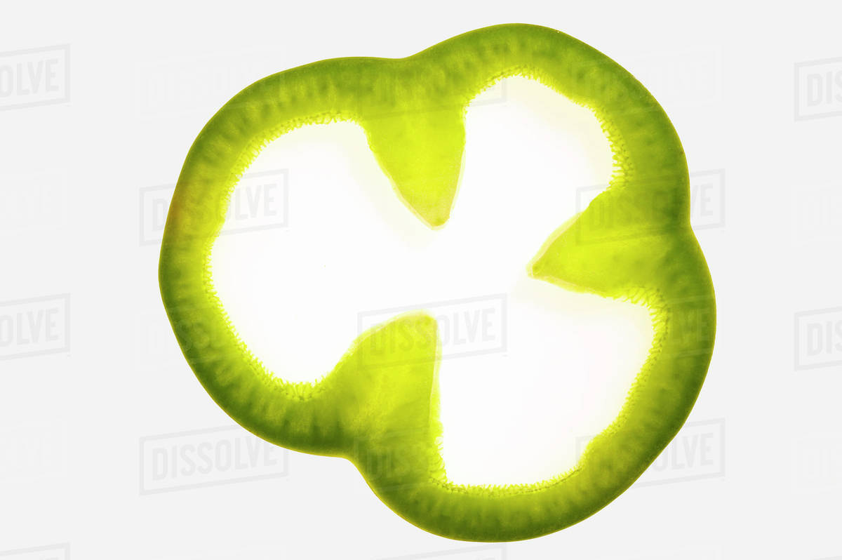 Slice of green pepper, backlit Stock Photo Dissolve