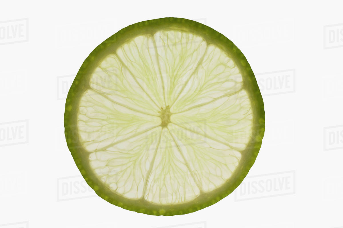 Slice of lime, backlit Stock Photo Dissolve