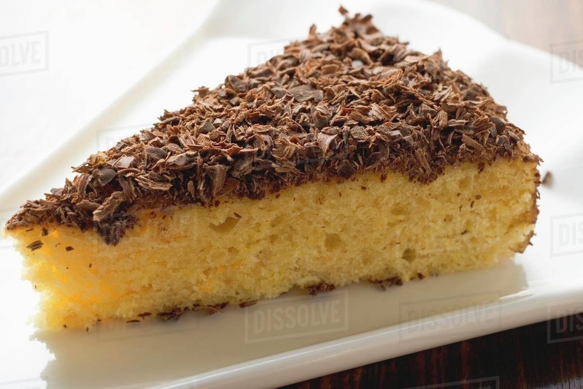 Piece of almond ricotta cake with dark chocolate Stock Photo Dissolve