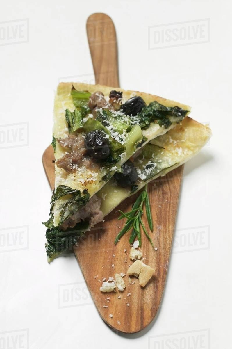 Flatbread with olives, mince, chard and Parmesan Stock Photo Dissolve