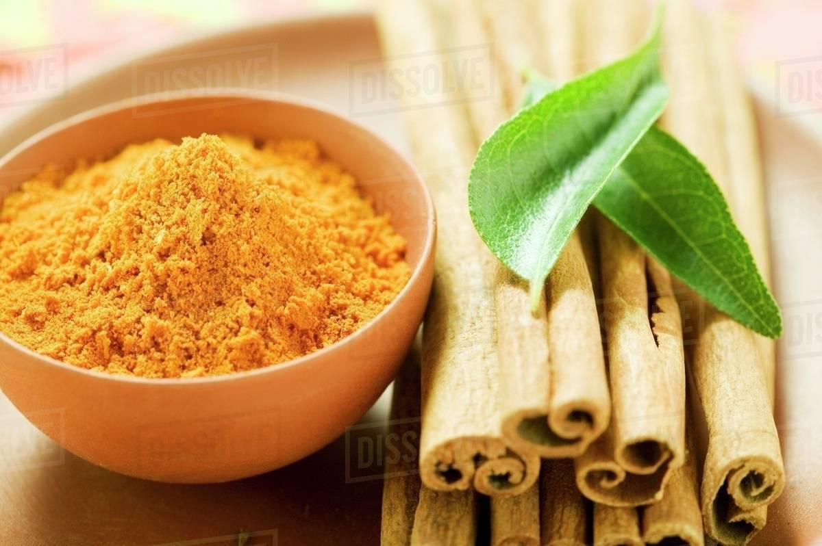 Cinnamon sticks, curry leaves and curry powder Stock Photo Dissolve