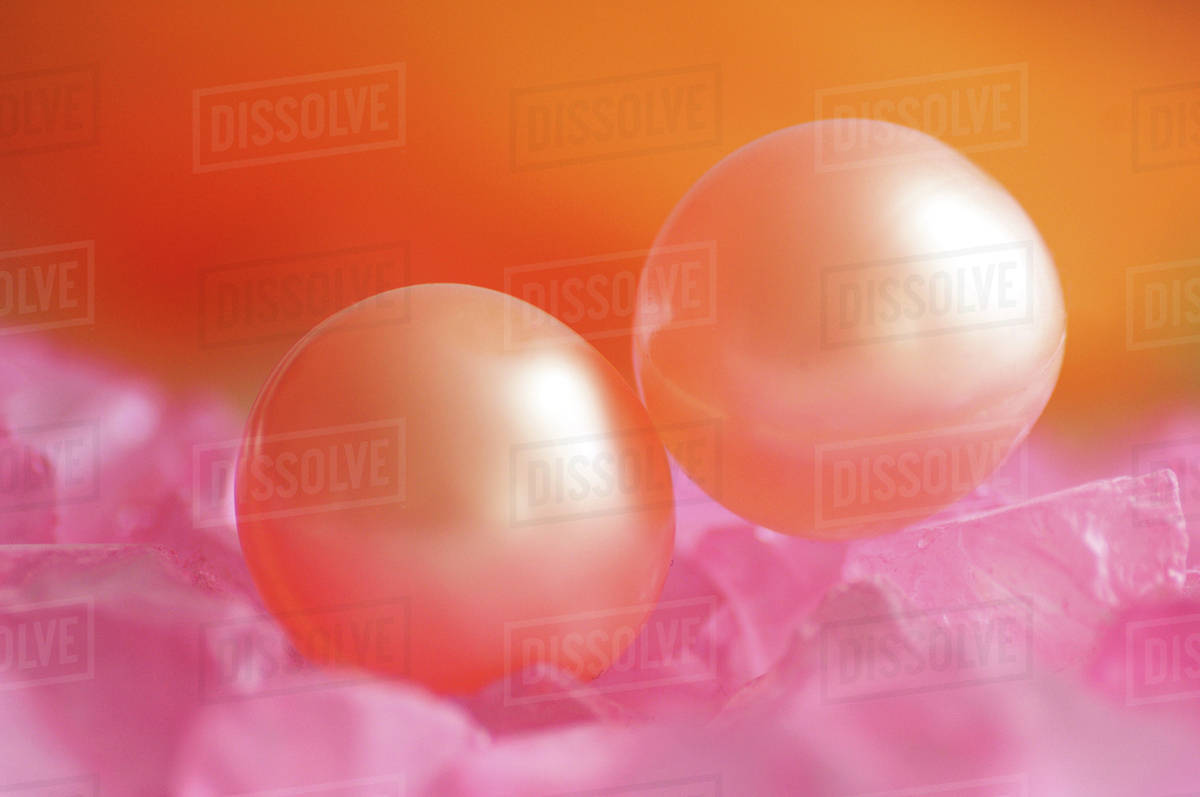 Two bath pearls, closeup Stock Photo Dissolve
