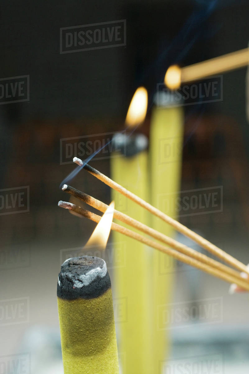 Lighting incense, closeup Stock Photo Dissolve