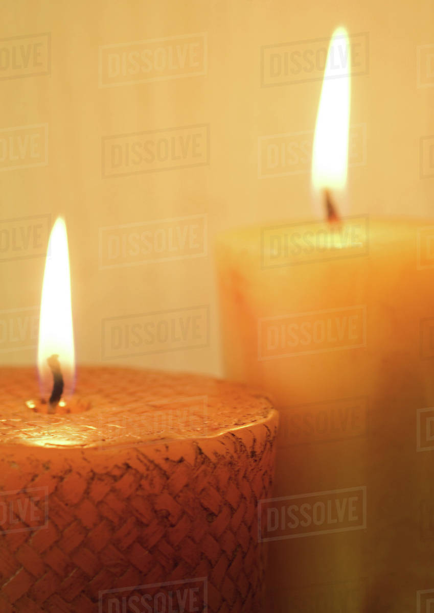 Two lit candles Stock Photo Dissolve