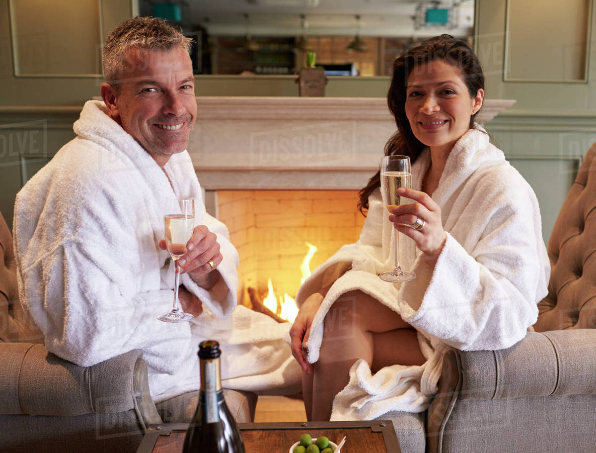 Couple wearing robes relaxing on hotel spa break Stock Photo Dissolve