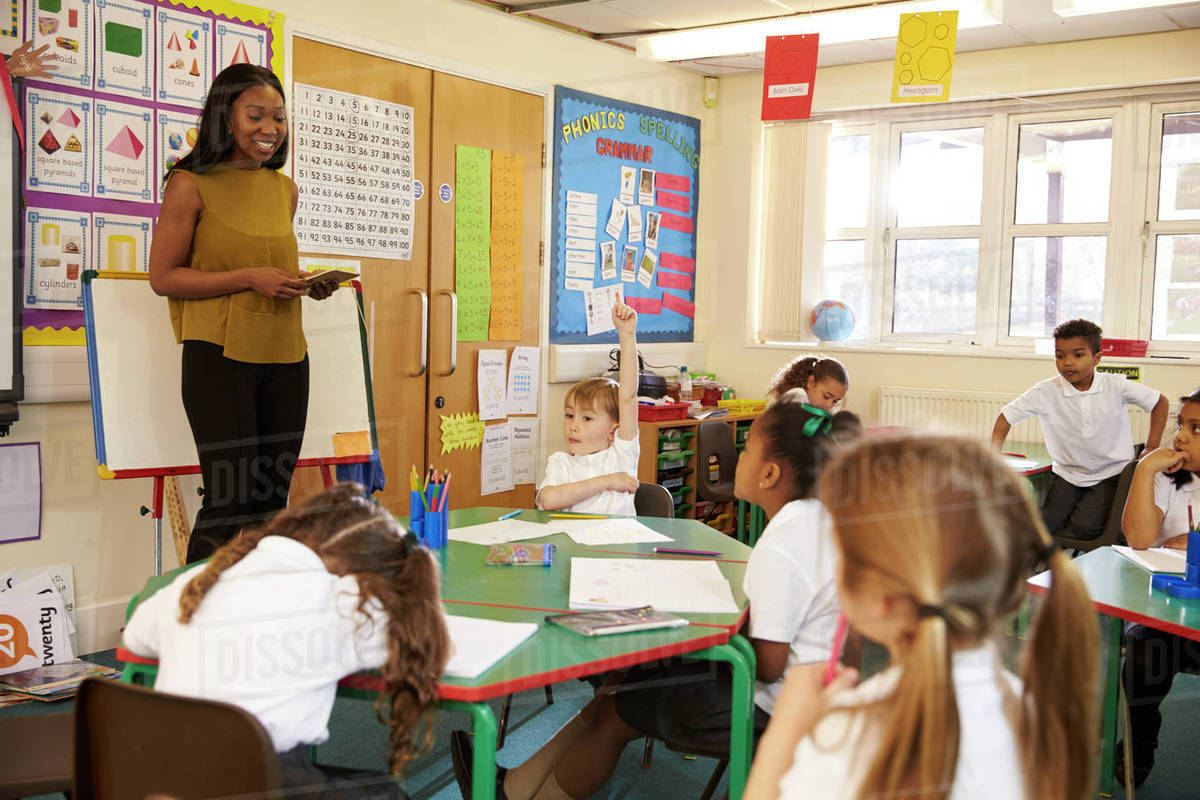 Teacher with digital tablet in elementary school classroom - Stock ...