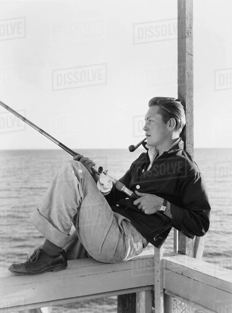 Man fishing and smoking pipe - Royalty-free Stock Photo