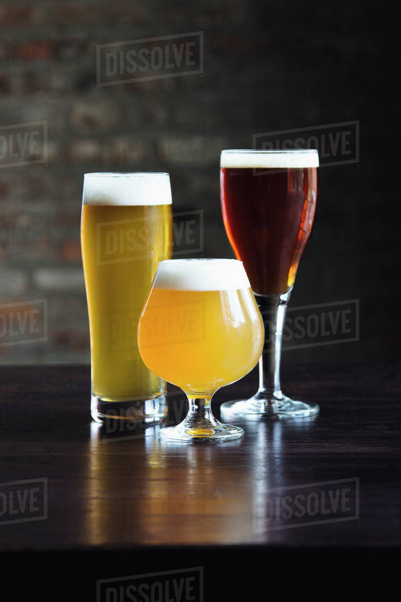 Various beers on table Stock Photo Dissolve