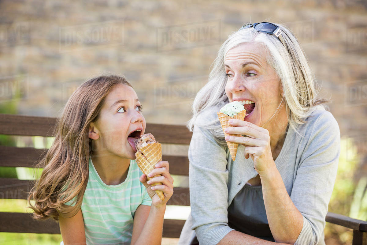 Caucasian Grandmother And Granddaughter Eating Ice Cream Stock