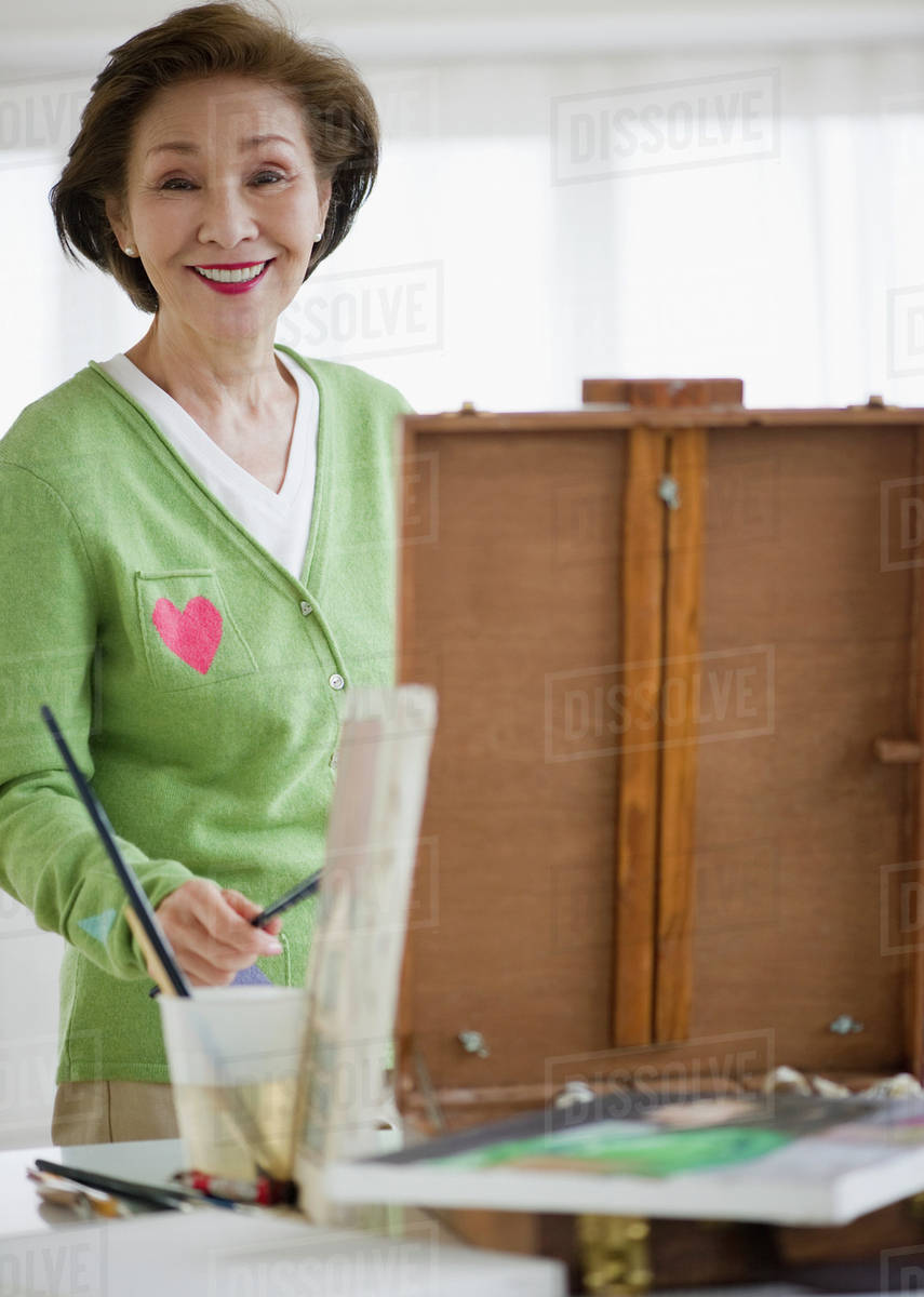 Japanese woman painting on easel Stock Photo Dissolve