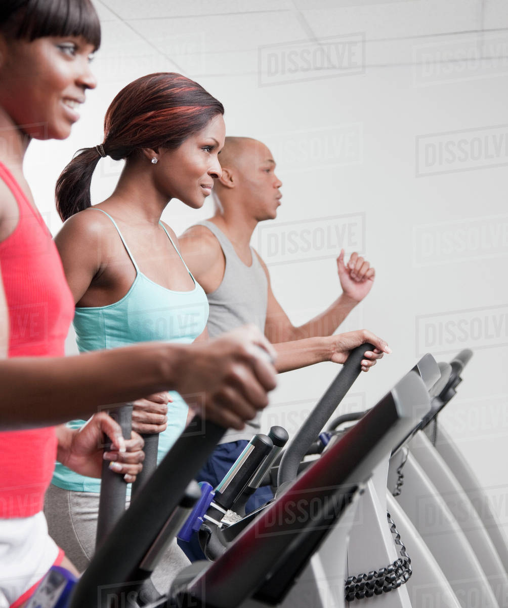 African people using exercise equipment in health club Stock Photo
