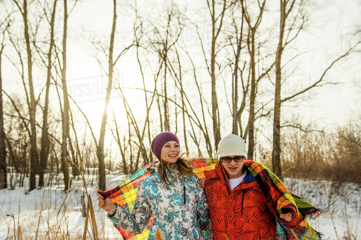Caucasian couple wrapped in blanket outdoors Stock Photo Dissolve