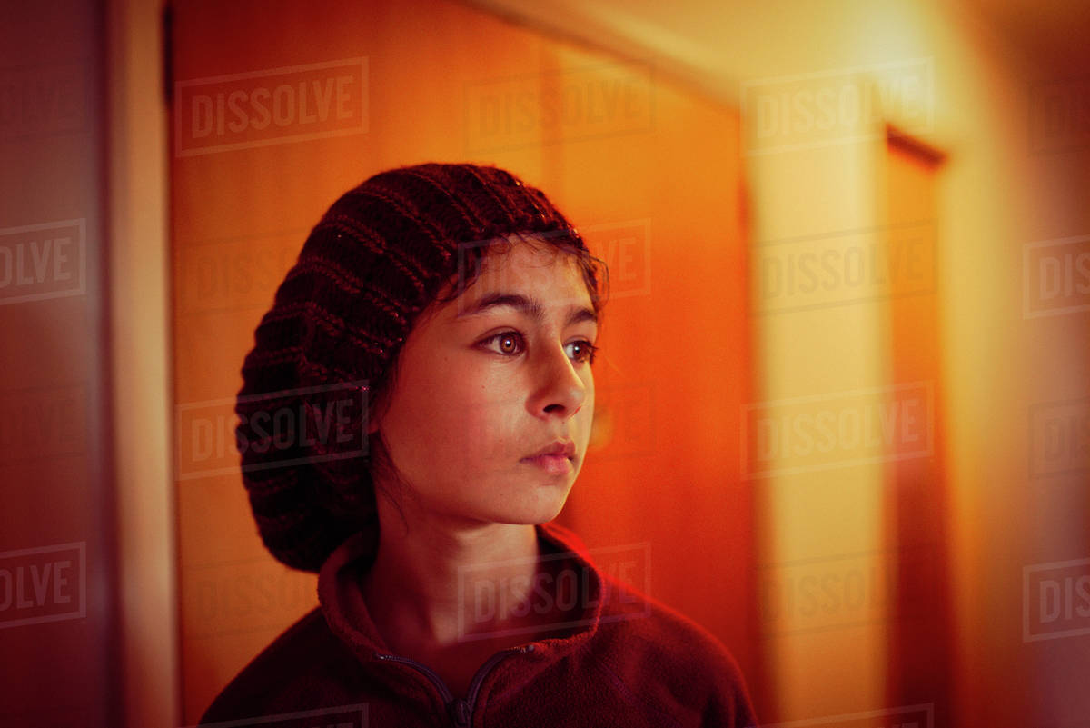 Mixed race girl standing in hallway Stock Photo Dissolve