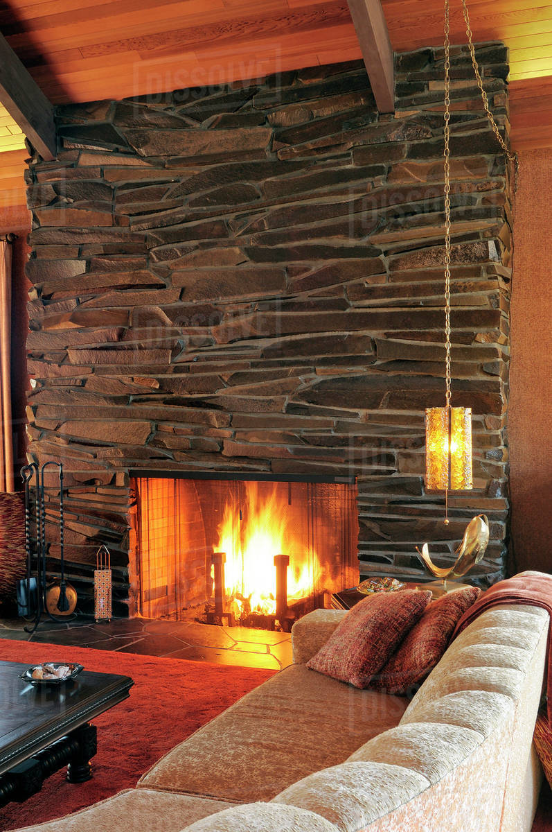 Sofa and fireplace in modern living room Stock Photo Dissolve