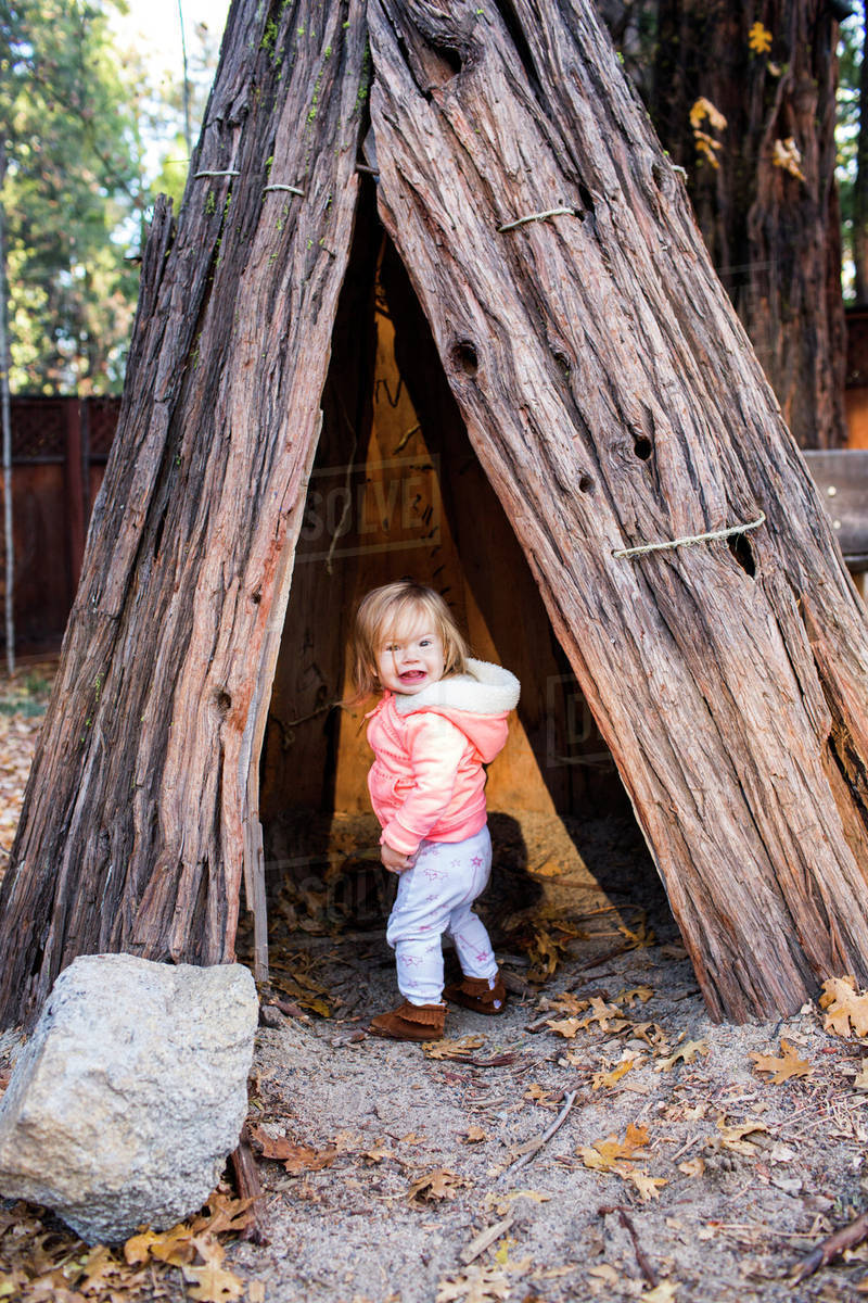 Caucasian baby girl playing in teepee Stock Photo Dissolve