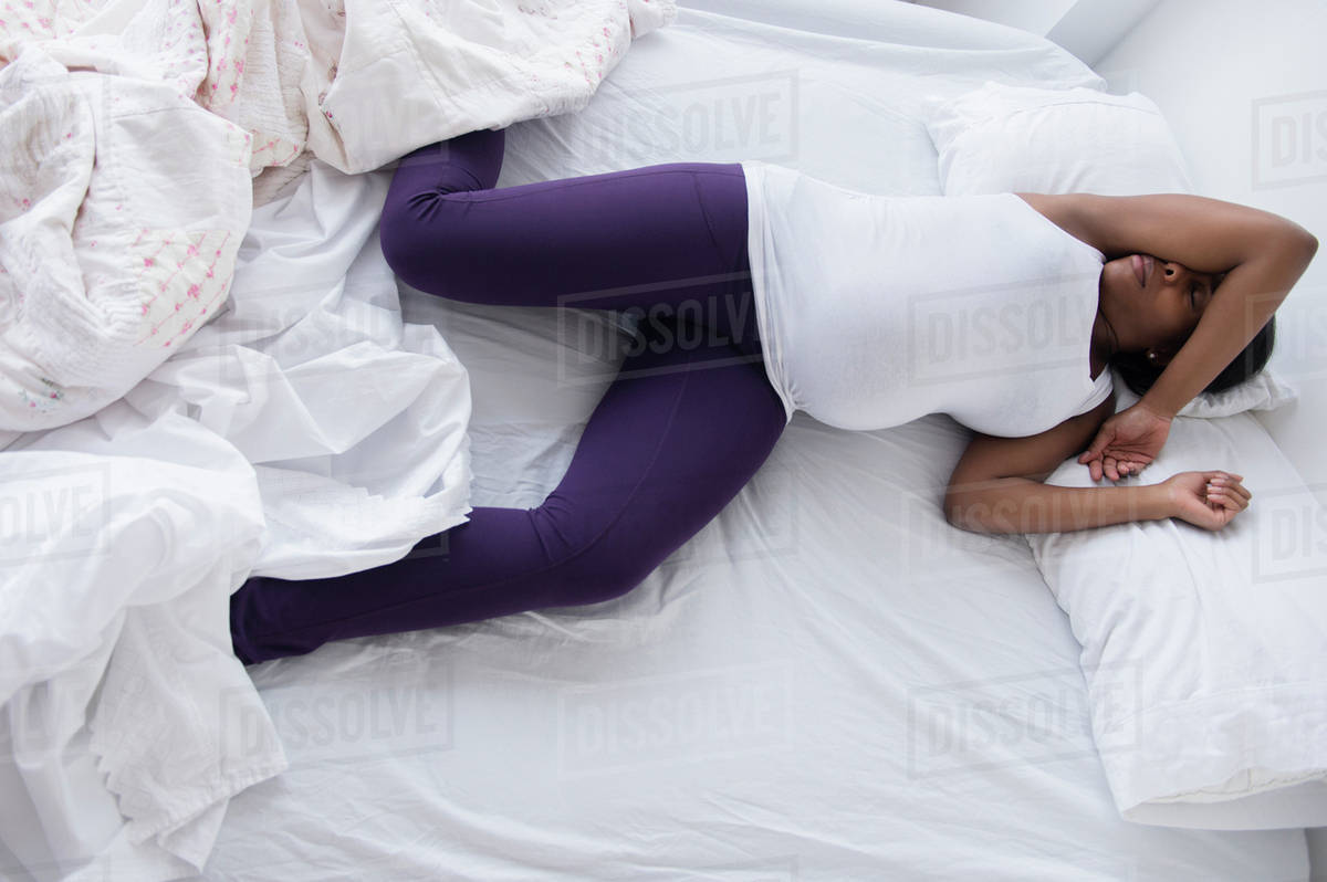 Black pregnant woman sleeping in bed Stock Photo Dissolve