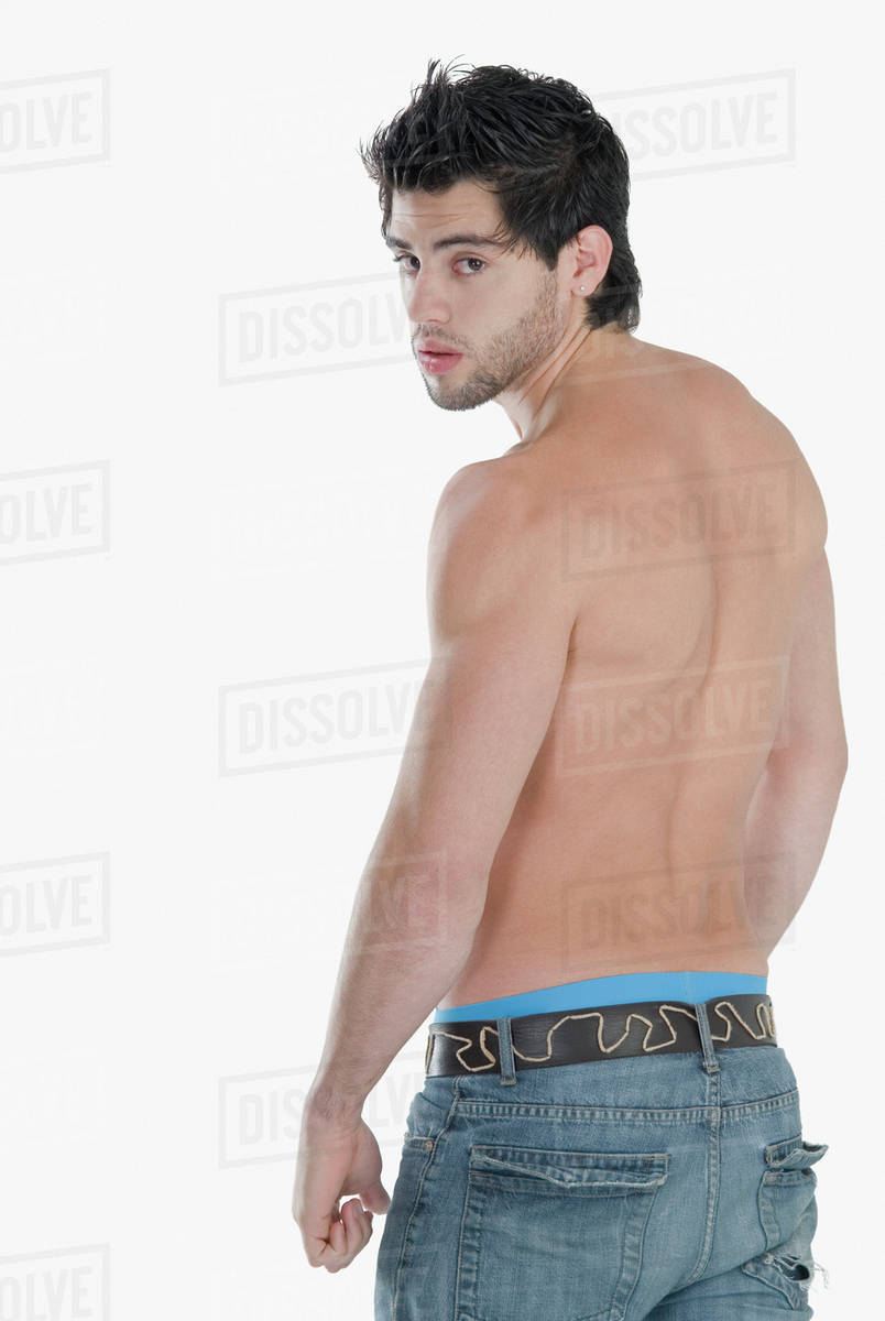 Barechested Hispanic man looking over shoulder Stock Photo Dissolve