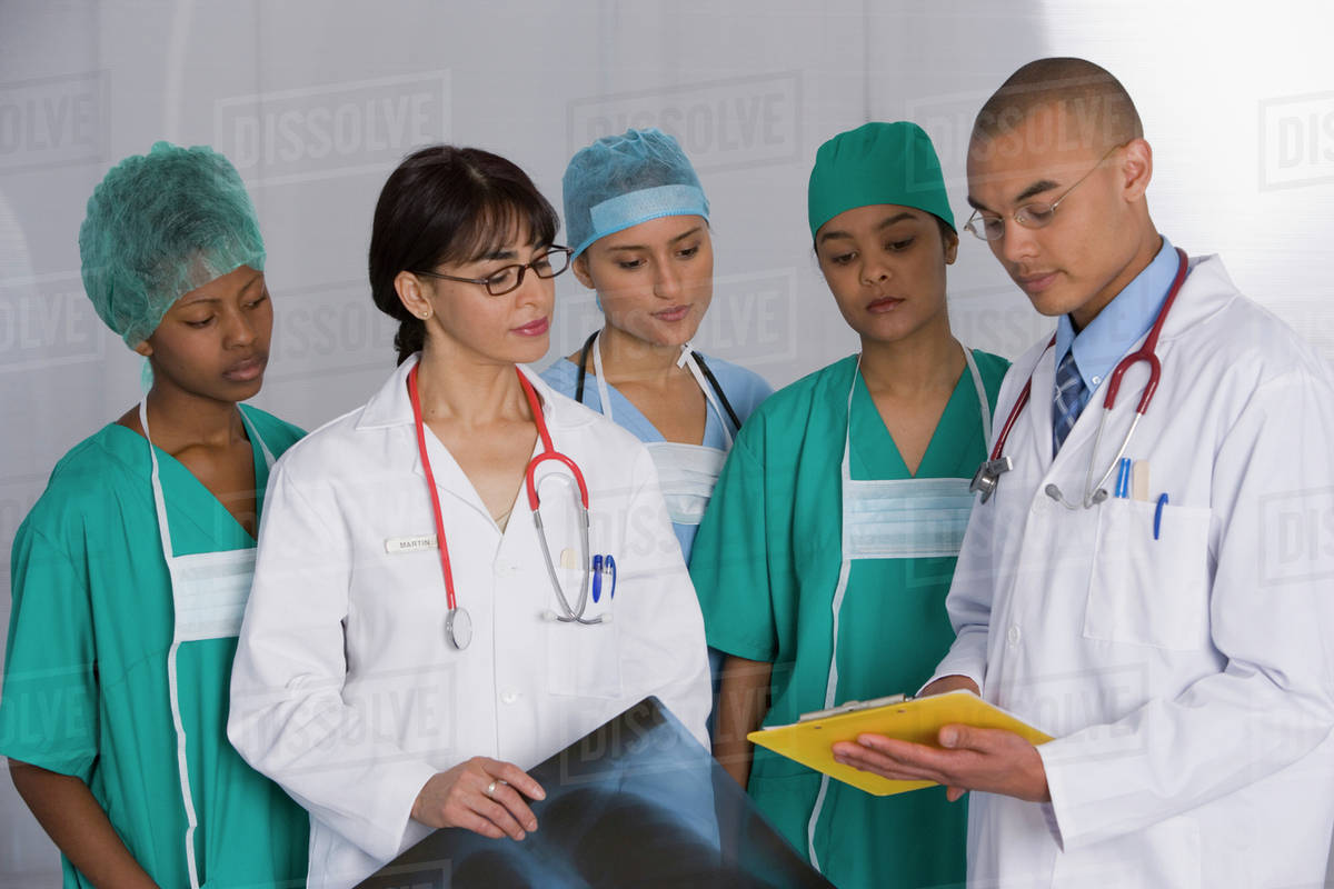 Multi-ethnic doctors discussing chart - Royalty-free Stock Photo | Dissolve