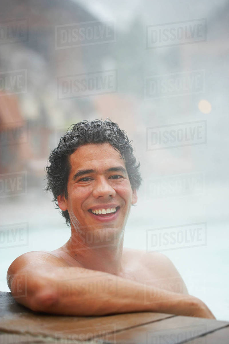 Man sitting in hot tub Stock Photo Dissolve