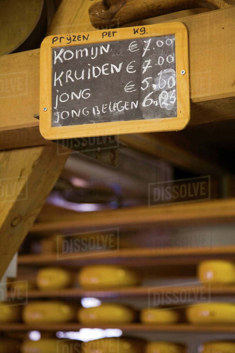 Wooden sign for cheese prices Stock Photo Dissolve