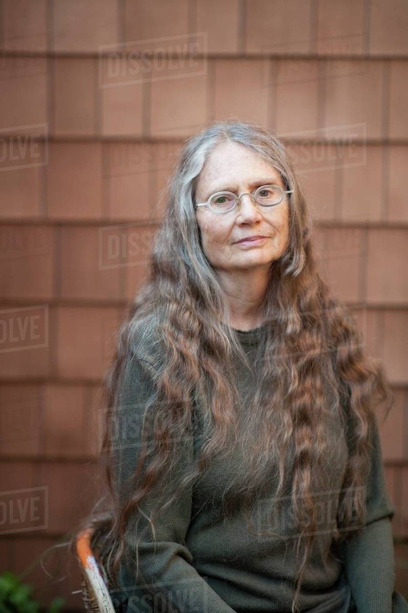 Older Woman Sitting Outdoors Stock Photo Dissolve