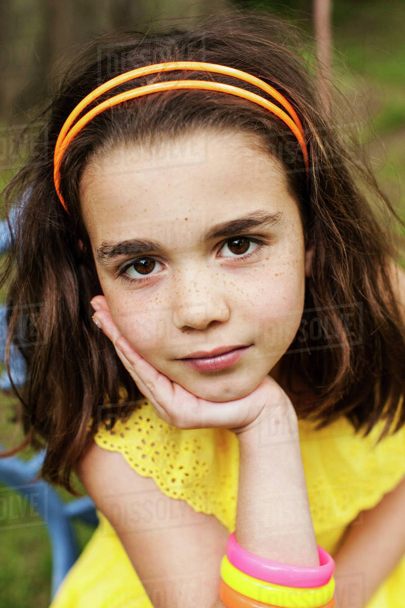 Close up of pensive girl resting chin in hand Stock Photo Dissolve