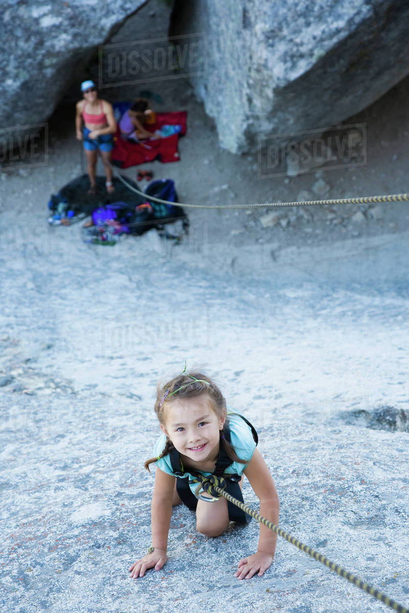 Asian girl rock climbing Stock Photo Dissolve