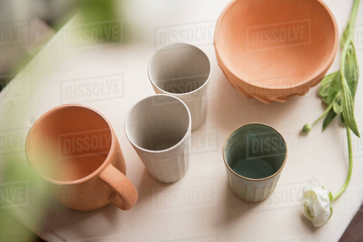 Cups and bowl on table Stock Photo Dissolve
