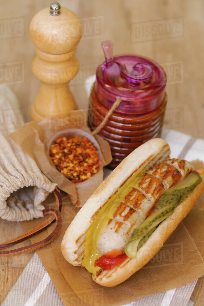 Grilled sausage in bun Stock Photo Dissolve