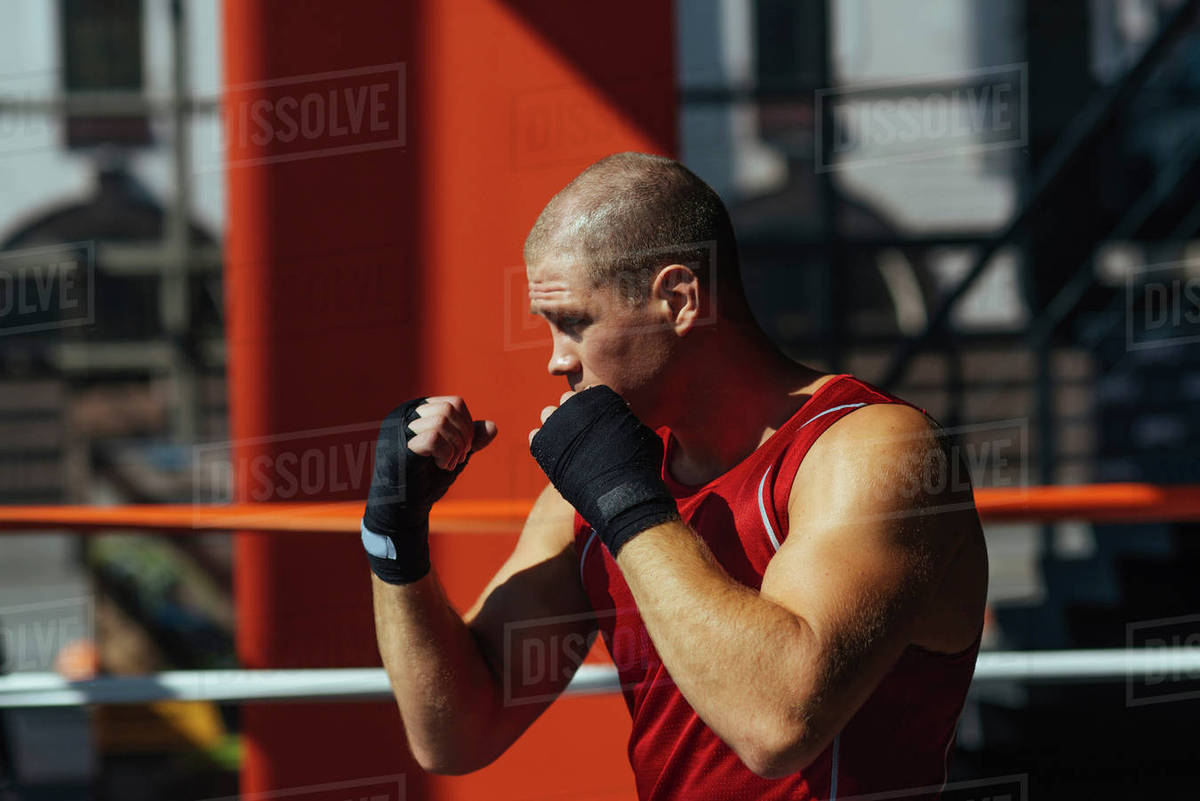 Portrait of Caucasian boxer with fists raised Stock Photo Dissolve