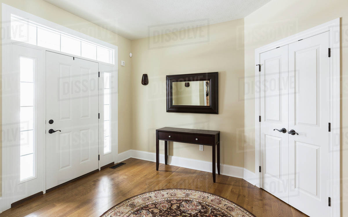 Table and mirror in modern entryway Stock Photo Dissolve