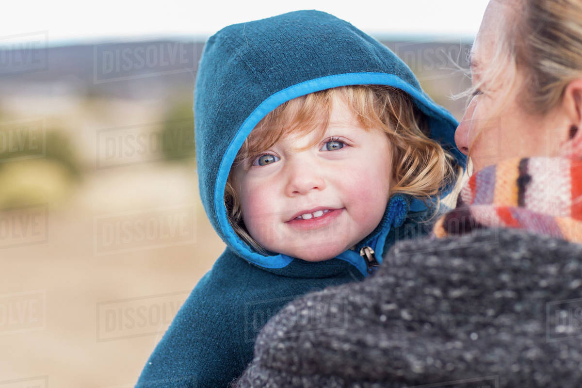 Caucasian mother carrying baby boy Stock Photo Dissolve