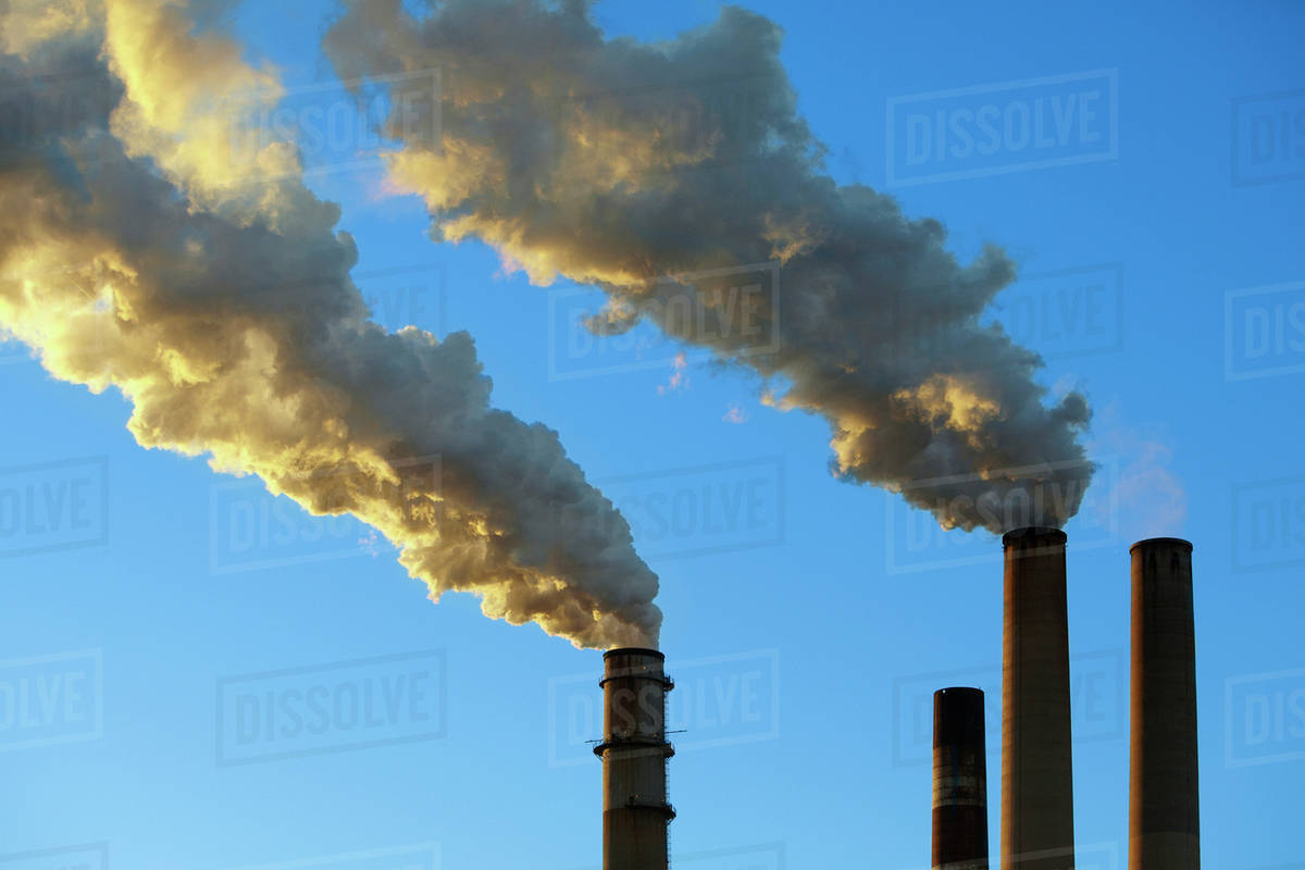 Smoke emitting from factory smoke stacks Stock Photo Dissolve