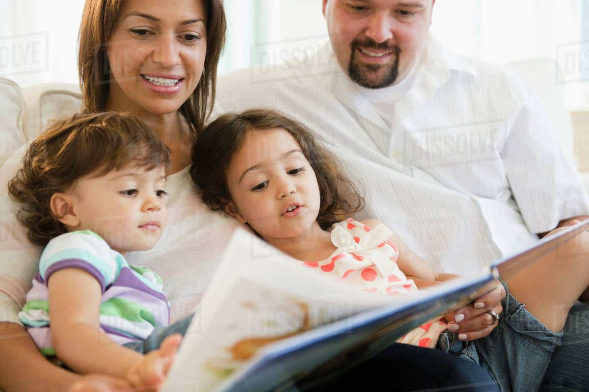 Family reading book together Stock Photo Dissolve