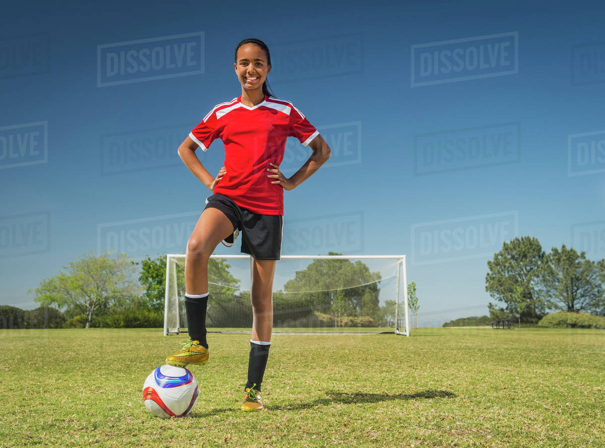 Mixed race soccer player standing on field Stock Photo Dissolve